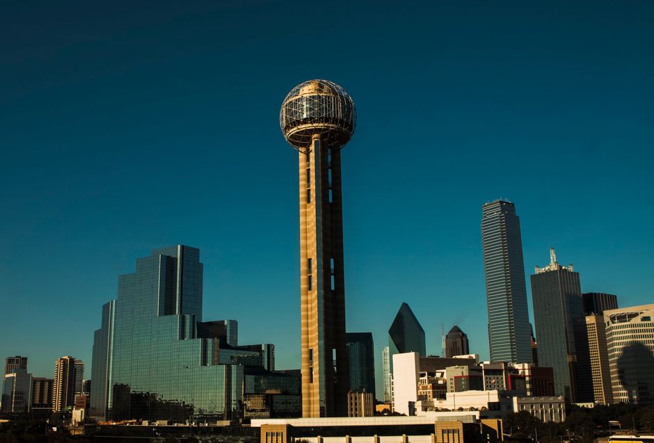 Iconic Dallas skyline with Reunion Tower under a clear blue sky.