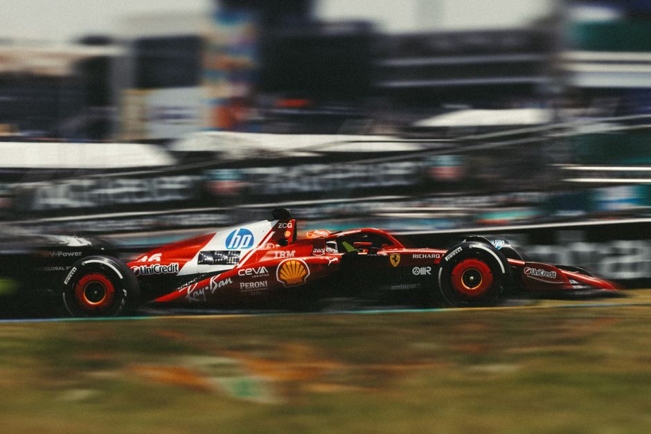 Ferrari F1 car racing at high speed on Interlagos racetrack in São Paulo, Brazil.