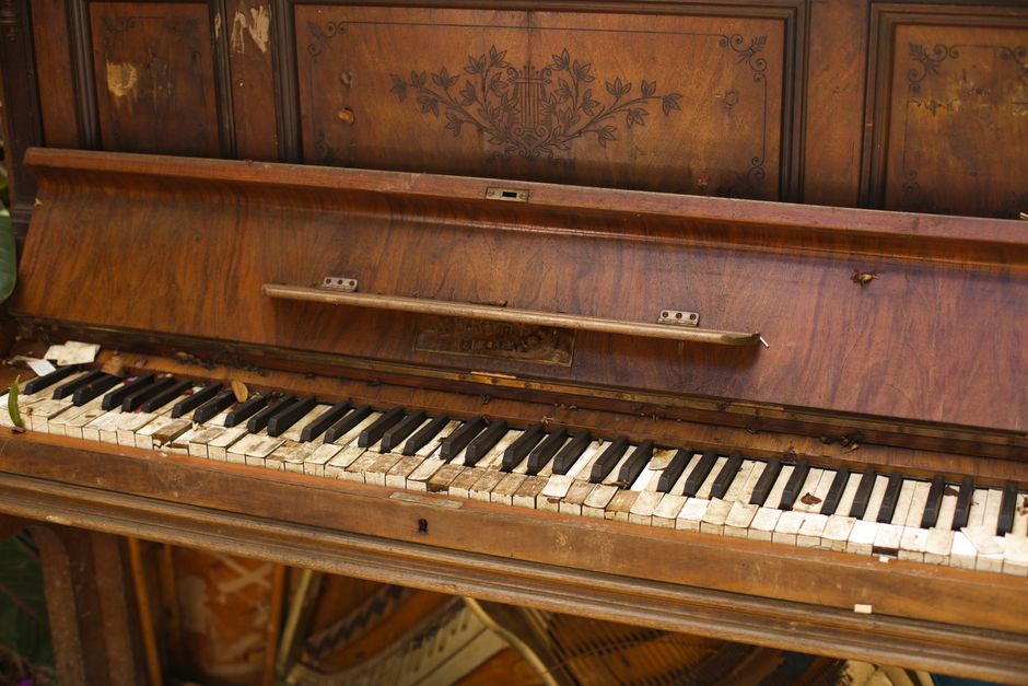Old wooden piano with aged keys, perfect for vintage or music-themed projects.