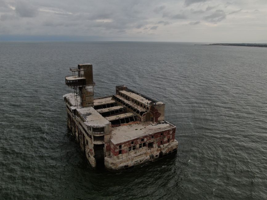 Aerial shot of a deserted factory surrounded by the Caspian Sea near Kaspiysk.