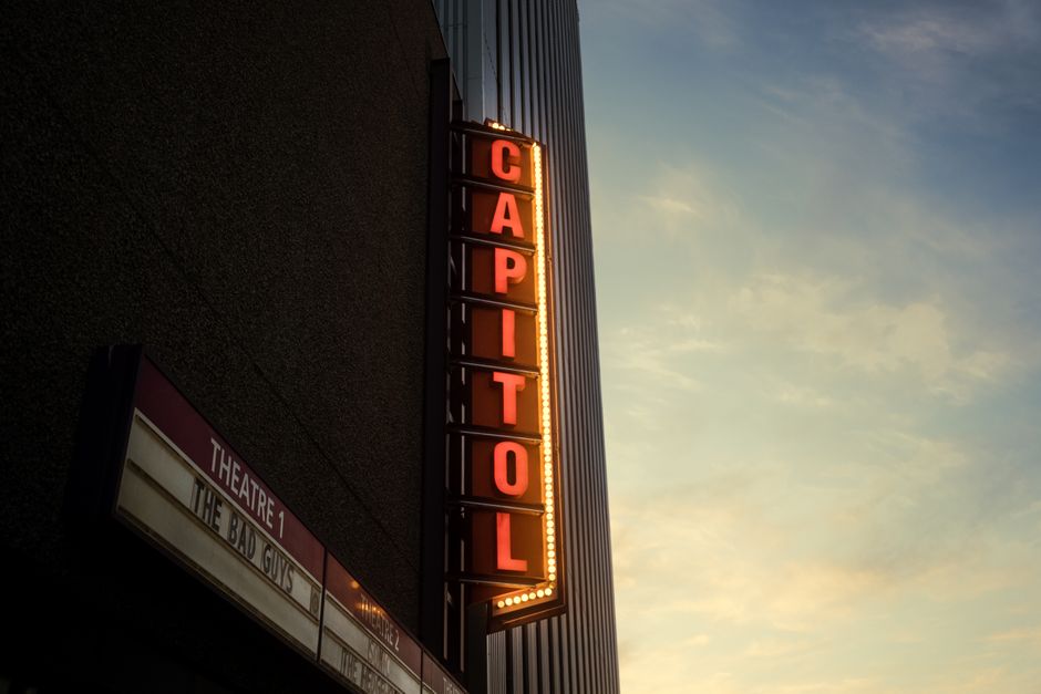 Illuminated Capitol Theatre sign against the evening sky, creating a nostalgic ambiance.