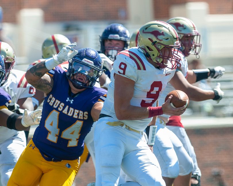 Players in a competitive American football game, showcasing athletic intensity.