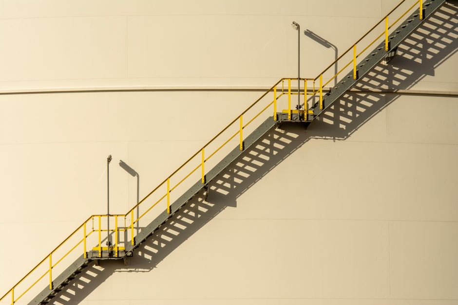 Minimalist industrial staircase casting shadows against a light wall.