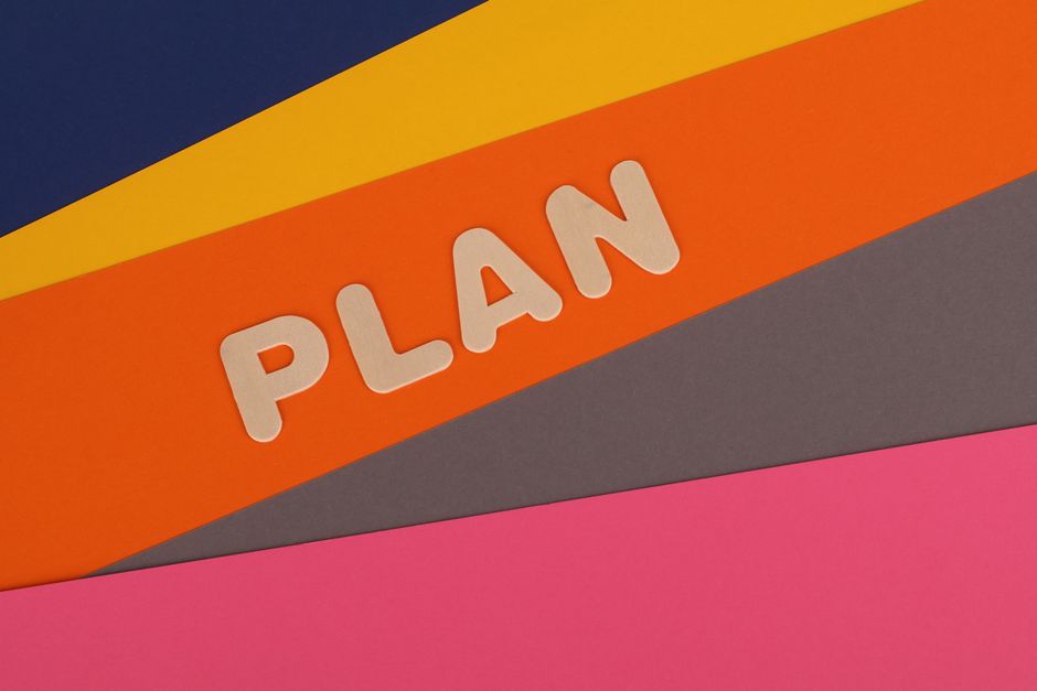 Vibrant geometric colored background with the word 'Plan' in bold letters, perfect for business concepts.
