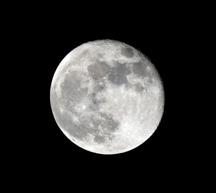 Stunning close-up photo of the full moon illuminating the night sky, highlighting lunar details.