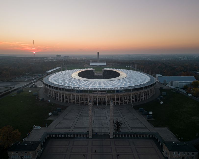 Captivating aerial view of Olympiastadion Berlin during sunset, showcasing its modern architecture.