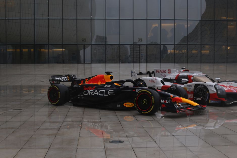 Red Bull and Toyota hypercars at Heydar Aliyev Center, Baku, showcasing motorsport excellence.