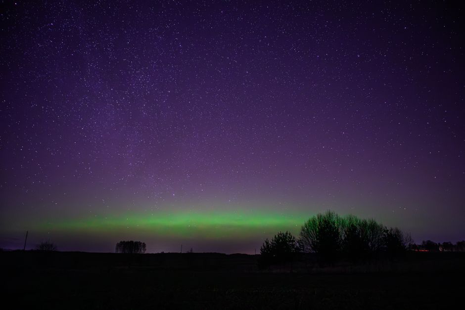 Mesmerizing view of the aurora borealis under a starry night sky.