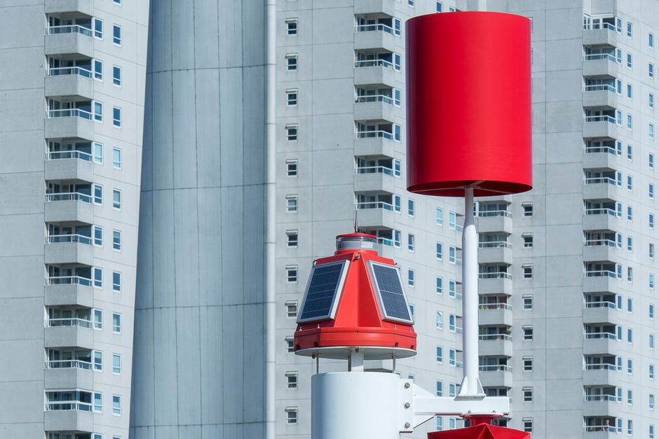 Urban cityscape featuring modern residential buildings with renewable energy installations in Rotterdam, Netherlands.