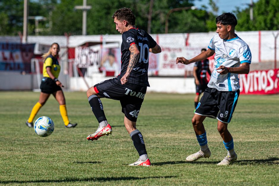 Exciting soccer match on a sunny day with players in action, showcasing dynamic gameplay.