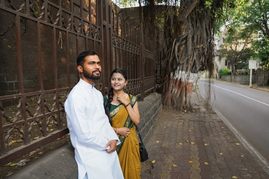 Smiling couple enjoying a stroll on a charming street in Pune, India. Perfect for lifestyle and travel themes.