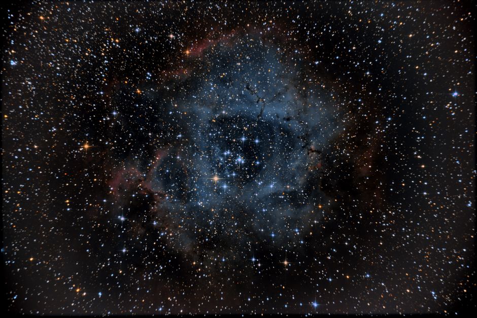 A breathtaking view of the Rosette Nebula surrounded by stars in deep space, showcasing cosmic beauty.