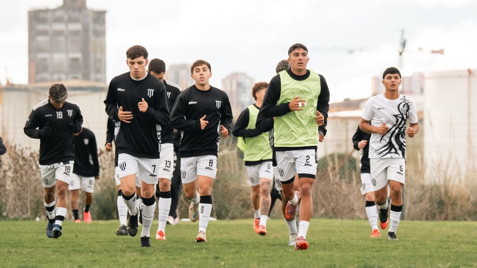 Youth soccer team training session, capturing focus and teamwork on an outdoor field.