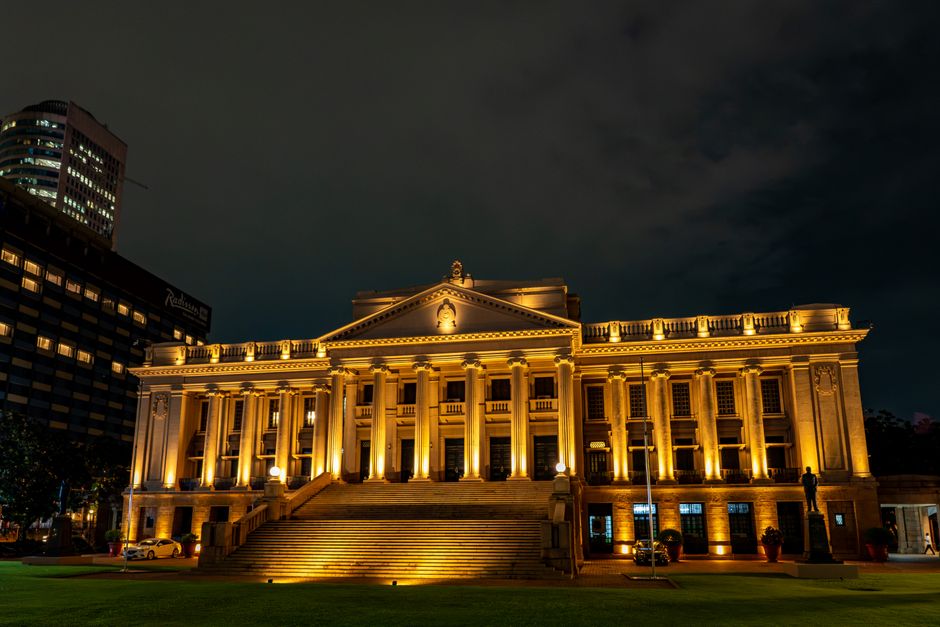 A beautifully lit colonial building at night in Colombo, Sri Lanka showcasing its architectural elegance.