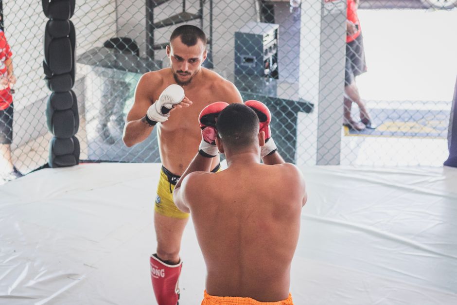 Two men sparring in a boxing ring, focusing on technique and skill.