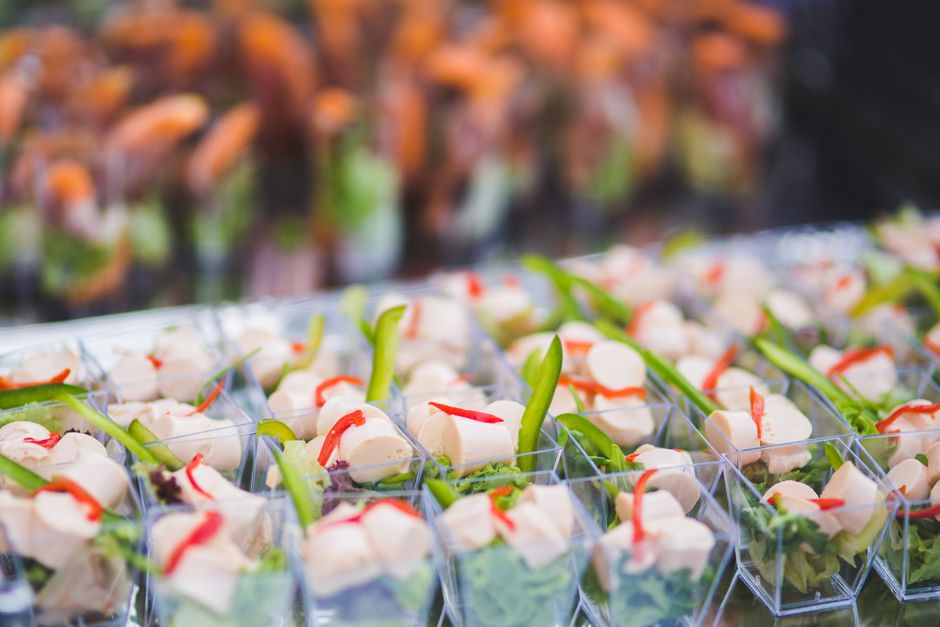 Vibrant assortment of vegetarian appetizers in small serving cups, perfect for parties and events.