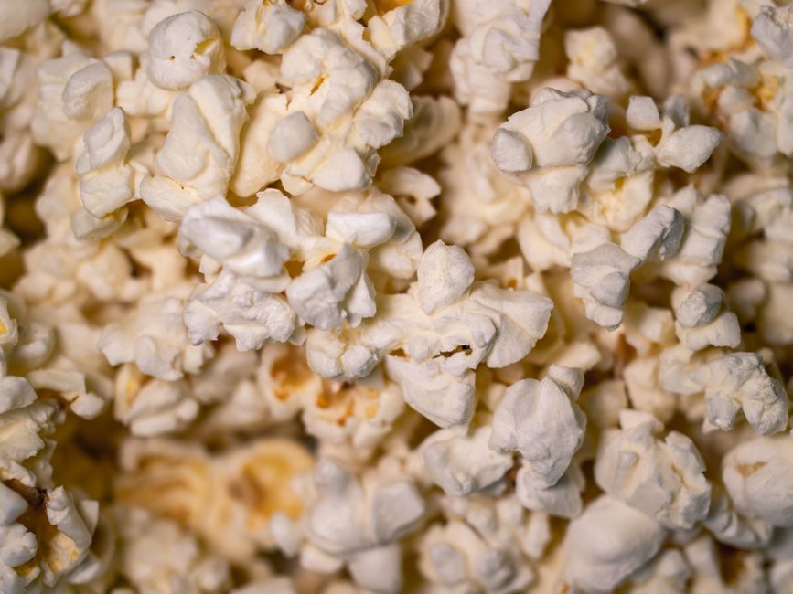 Detailed close-up of freshly popped buttery popcorn, perfect as a snack wallpaper.